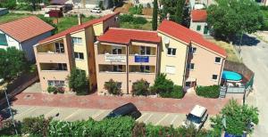 an aerial view of a house with a parking lot at Apartments Solaris in Sveti Filip i Jakov