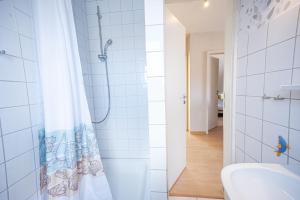 a bathroom with a shower curtain and a sink at An der Aue 15 Wohnung Ley in Dahme
