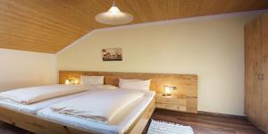 Landhaus Petra في باد فسينغ: غرفة نوم بسرير كبير وسقف خشبي