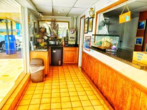 a restaurant with a counter and a yellow tiled floor at The Port Hotel and Marina in Crystal River
