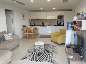 a kitchen and living room with a zebra print rug at Lavender Residence in Kusadası