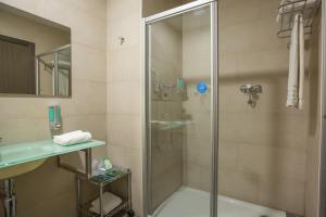 a bathroom with a glass shower with a sink at Hotel Venture Sant Cugat in Sant Cugat del Vallès