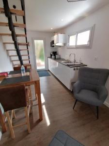 a kitchen and dining room with a table and a sink at Concept Appart'Hôtel Lannion - Côte de Granit Rose in Lannion