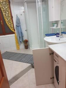 a bathroom with a shower and a sink at Palma BnB in Maracalagonis