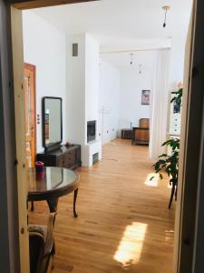 a living room with a table and a mirror at Dům Bublina in Veselí nad Moravou