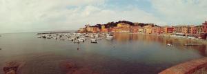 a group of boats in the water near a city at Hotel Sereno in Sestri Levante