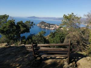 a bench sitting on top of a hill overlooking a lake at Hotel Sereno in Sestri Levante