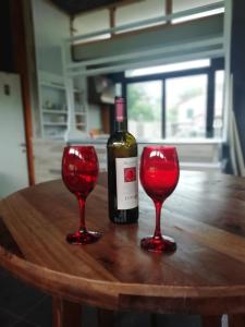 a bottle of wine and two red glasses on a table at Hotel Sereno in Sestri Levante