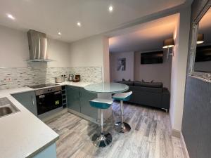 a kitchen with a glass table and a couch at Apartments No. 19 in Portpatrick