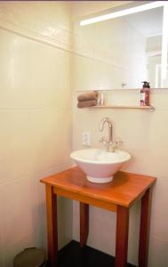a bathroom with a white sink and a mirror at Logement Garjen in Harlingen