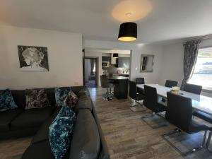 a living room with a couch and a table at Apartments No. 19 in Portpatrick