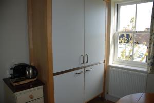 a kitchen with a large white cabinet and a window at Over Studio Apartment in Over