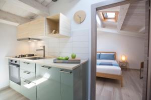 a kitchen with a sink and a bed in a room at Funduq ospitalità iblea in Pozzallo