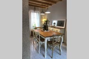 a dining room table with chairs and a television at Casa Casco Antiguo A Guarda in A Guarda +10 photos