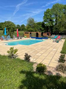 a swimming pool with lounge chairs at Maison Tranquille in Champniers-et-Reillac