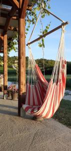a red and white hammock hanging from a gazebo at Terre del Piano-Bell Tent in Corinaldo