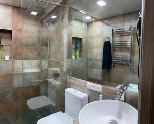 a bathroom with a toilet and a sink and a shower at CITY VIEW PENTHOUSE in Yerevan