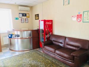 a living room with a couch and a coffee table at Гостевой дом Альфа in Rostov on Don
