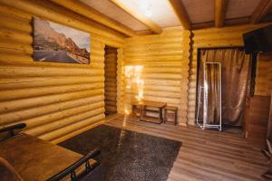 a room in a log cabin with a table and chairs at Nika2 Hotel in Zatoka