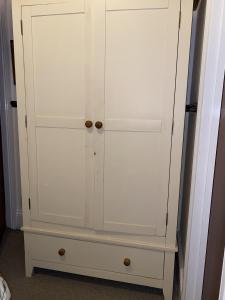 a white cabinet with two doors in a room at Seaford Lodge Apartments in Weston-super-Mare