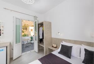 a bedroom with a bed and a sliding glass door at Aislin House in Kamari