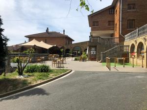 a building with a patio with tables and chairs at Pensión Ametzagaña in San Sebastián