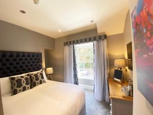 a bedroom with a large bed and a window at Aberdunant Hall in Porthmadog