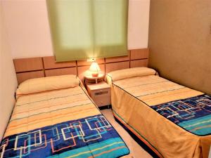 Ein Bett oder Betten in einem Zimmer der Unterkunft ACV - Valparaiso - 2ª linea, planta 3, norte