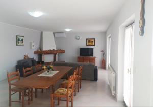 a dining room with a table and chairs and a couch at Apartment Davorka in Vrsar