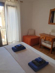 a bedroom with two blue towels on a bed at oasis RELAX Corralejo in Parque Holandes +26 photos