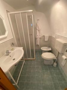 a bathroom with a toilet and a sink and a shower at SALENTO NONNI in Matino