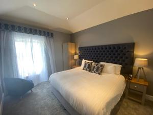 a bedroom with a large bed and a window at Aberdunant Hall in Porthmadog