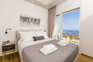 A bed or beds in a room at Chrysi's Ocean View Retreat
