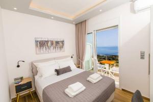 A bed or beds in a room at Chrysi's Ocean View Retreat