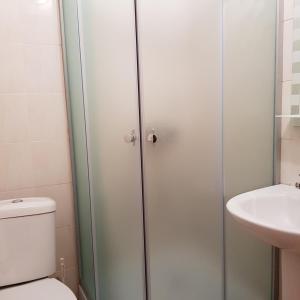 a bathroom with a shower and a toilet and a sink at Nika2 Hotel in Zatoka +82 photos