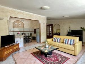 a living room with a couch and a table at Home Sweet Home in Gallicano nel Lazio
