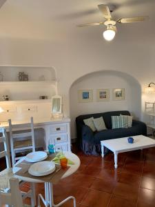 a living room with a table and a couch at Casa Nenna, centro di Forio in Ischia