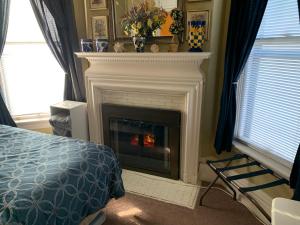 a fireplace in a bedroom with a fire place at Bayberry House Bed and Breakfast in Steubenville