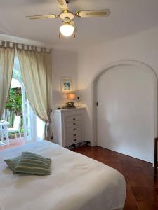a bedroom with a bed and a ceiling fan at Casa Nenna, centro di Forio in Ischia