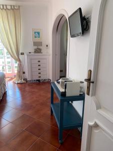 a room with a desk and a tv on a wall at Casa Nenna, centro di Forio in Ischia +34 photos
