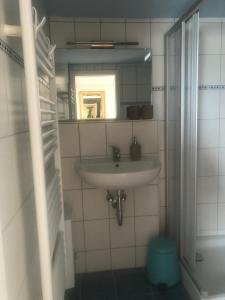 a bathroom with a sink and a mirror at Hering FeWo II Apartment Balcony in Wiek auf Rügen  +35 photos
