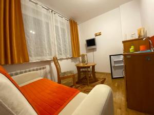 クリニツァ・ズドルイにある2-pokojowe Apartamenty KAMIL Krynica-Zdrójのベッドルーム1室(ベッド1台、テーブル、窓付)