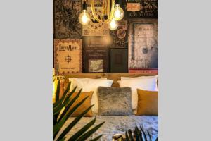 a bedroom with a bed and a wall with posters at Un petit Vintage à Colmar in Colmar