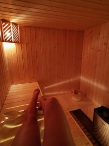 a person is laying in a sauna at Sindy Wooden Apartments in Mavrovo