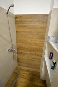 a shower with a wooden floor in a bathroom at Balcony 4 bedroom apartment by Book-Rijeka in Rijeka