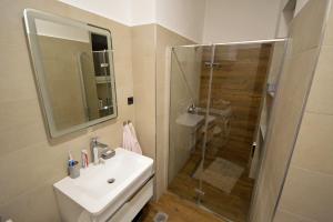 a bathroom with a sink and a shower at Balcony 4 bedroom apartment by Book-Rijeka in Rijeka +21 photos