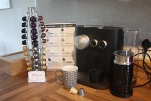 a coffee maker sitting on a table with a cup at Berwicks House - NEC & Airport - Stylish 3-bed house with garden in Birmingham