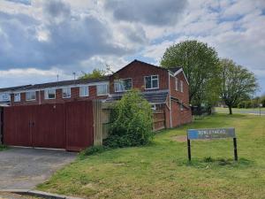 a house with a sign in front of it at 5 Bedroom House All ensuite...sleeps up to 10 in Swindon