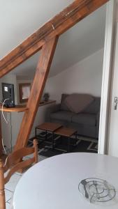 a living room with a table and a couch at Appartement 3 personnes tout équipé VOSGES. in Rochesson