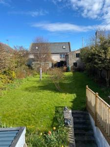 a house with a yard with a fence and a house at Chemist's House in Cullen